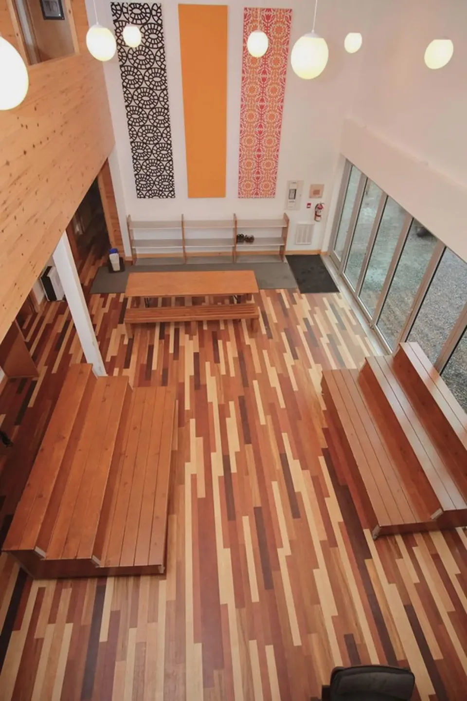 Modern interior with patterned wood flooring and benches