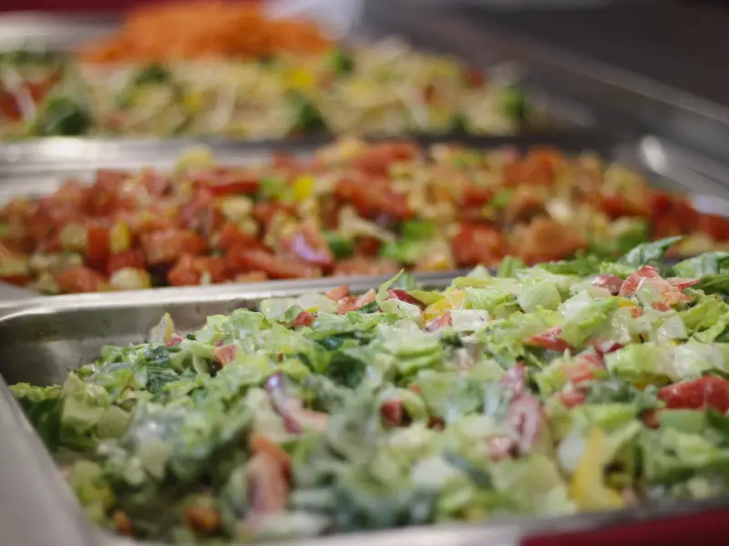 Buffet trays filled with fresh mixed salads