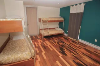 Bedroom with two bunk beds and hardwood floors