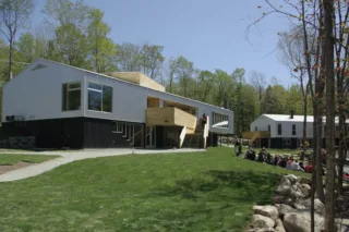 Modern wood and white building with people outside