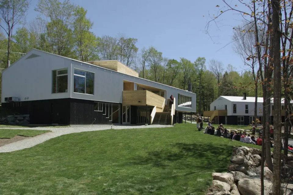 Modern wood and white building with people outside
