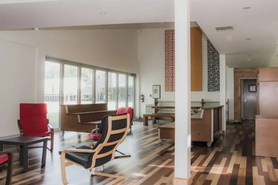 Modern lounge area with wooden floors and large windows