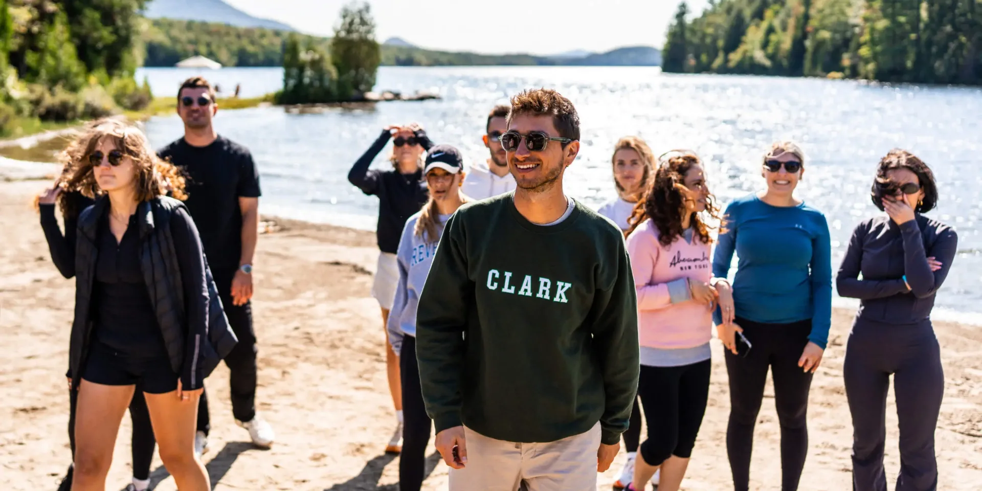 Group of friends on sunny lakeside beach