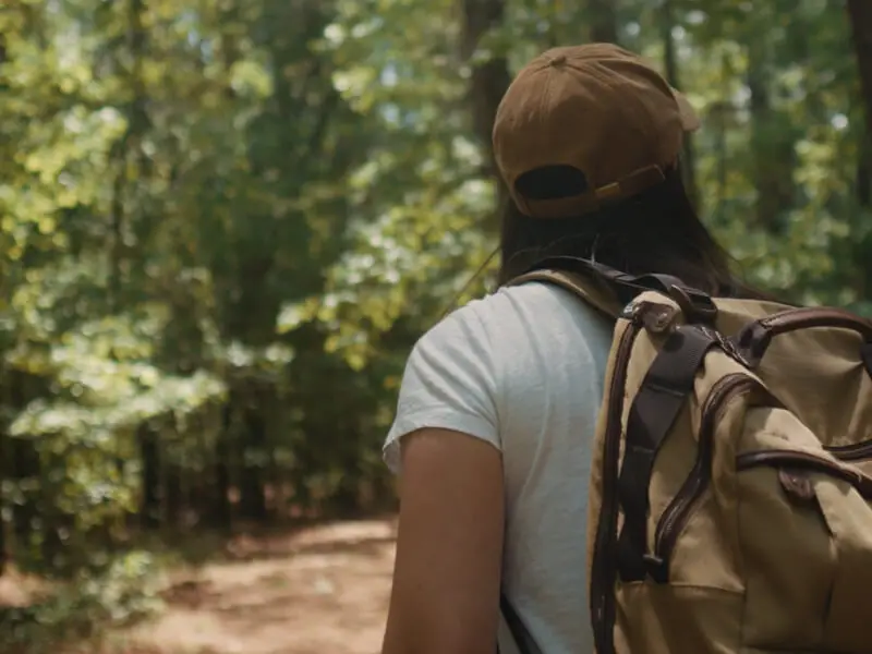 Person with backpack in forest