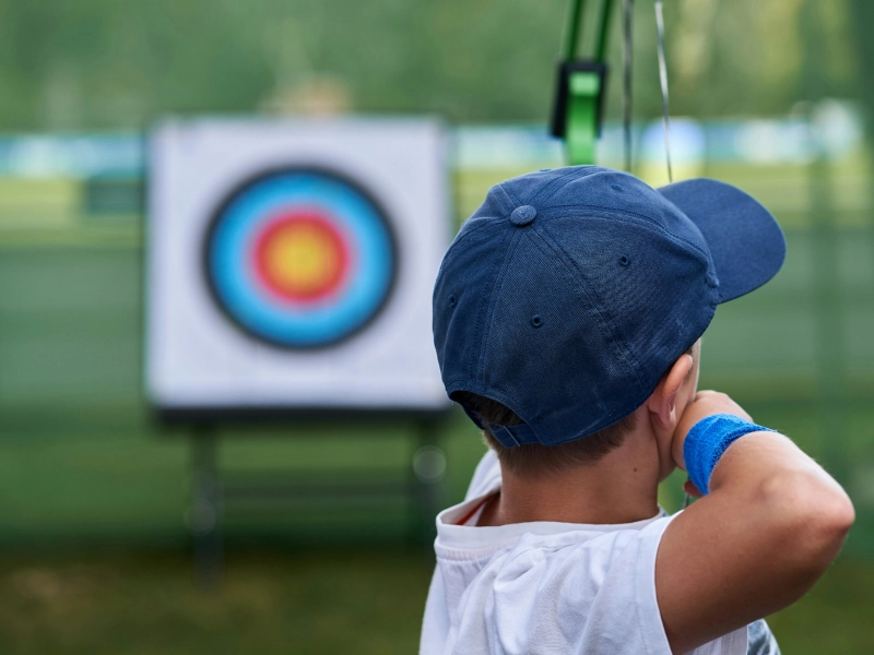 Enfant tirant à l’arc vers une cible