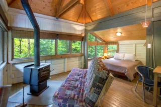 Cozy wooden cabin bedroom with forest view
