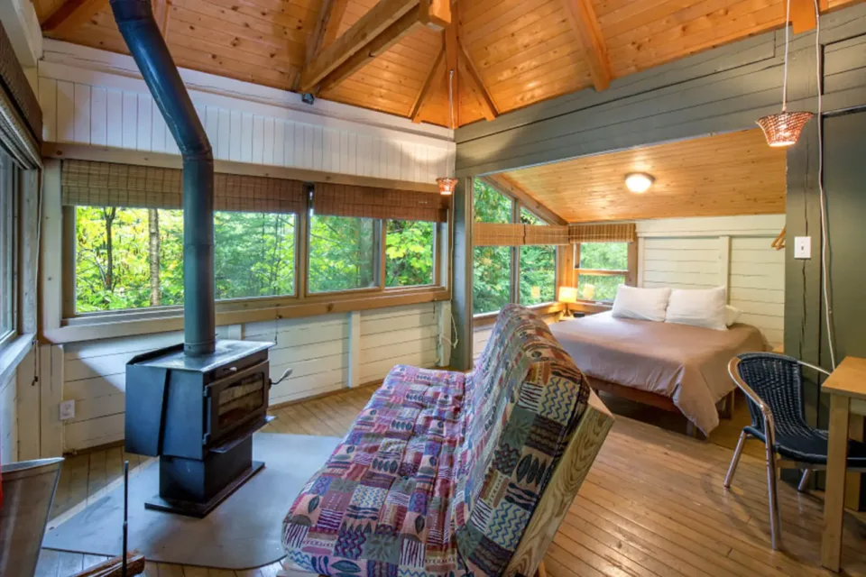 Cozy wooden cabin bedroom with forest view