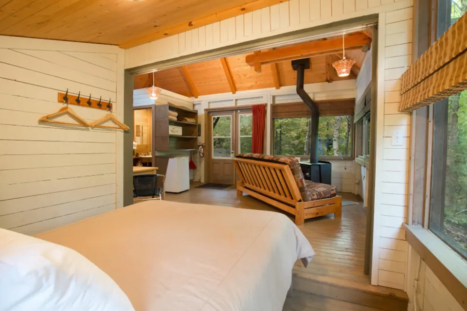 Cozy rustic cabin interior with bed and wood stove