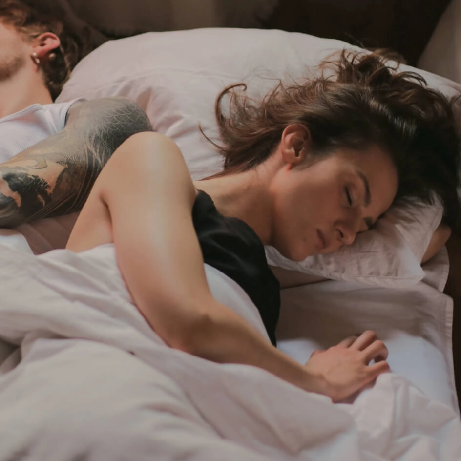 Couple sleeping peacefully in bed together