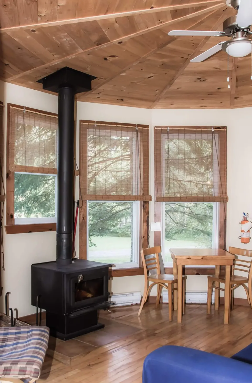 Cozy cabin interior with wood stove and table