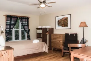 Cozy bedroom with wooden furniture and window.