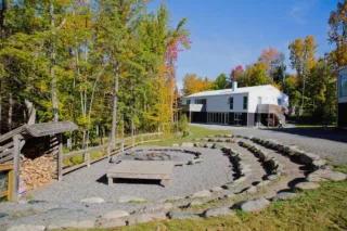 Modern building with fire pit in autumn forest