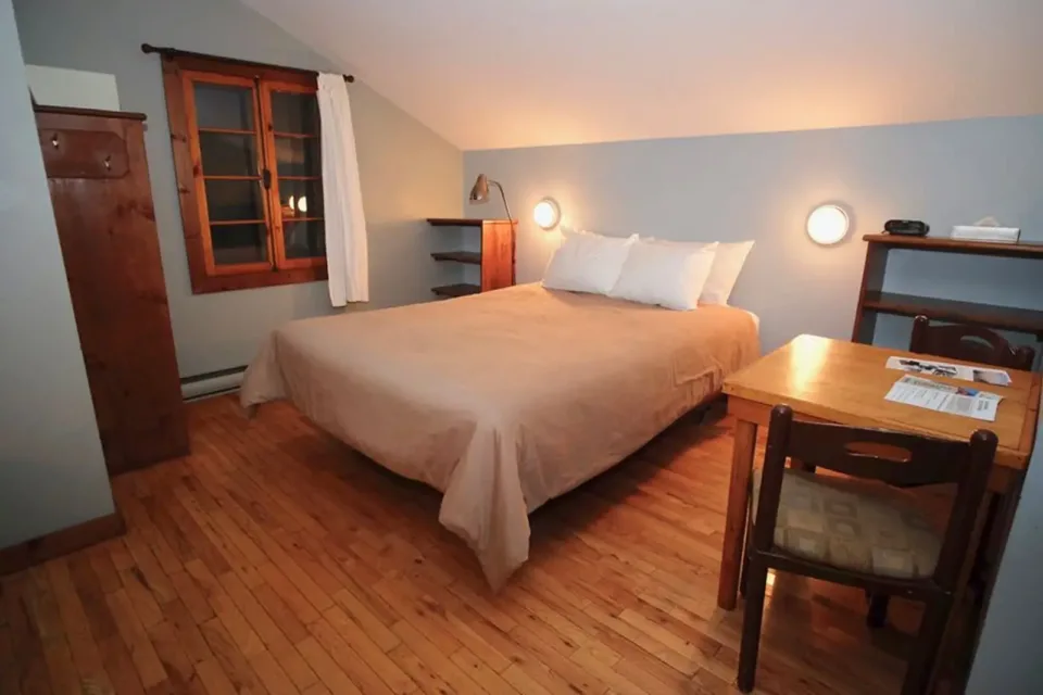 Cozy bedroom with wooden floors and large bed