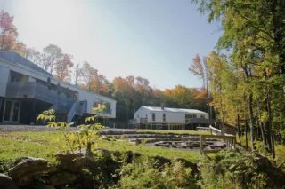 Modern buildings surrounded by autumn forest landscape