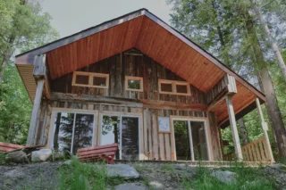 Rustic wooden cabin surrounded by forest trees