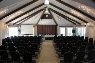 Salle de conférence avec chaises et écran de projection