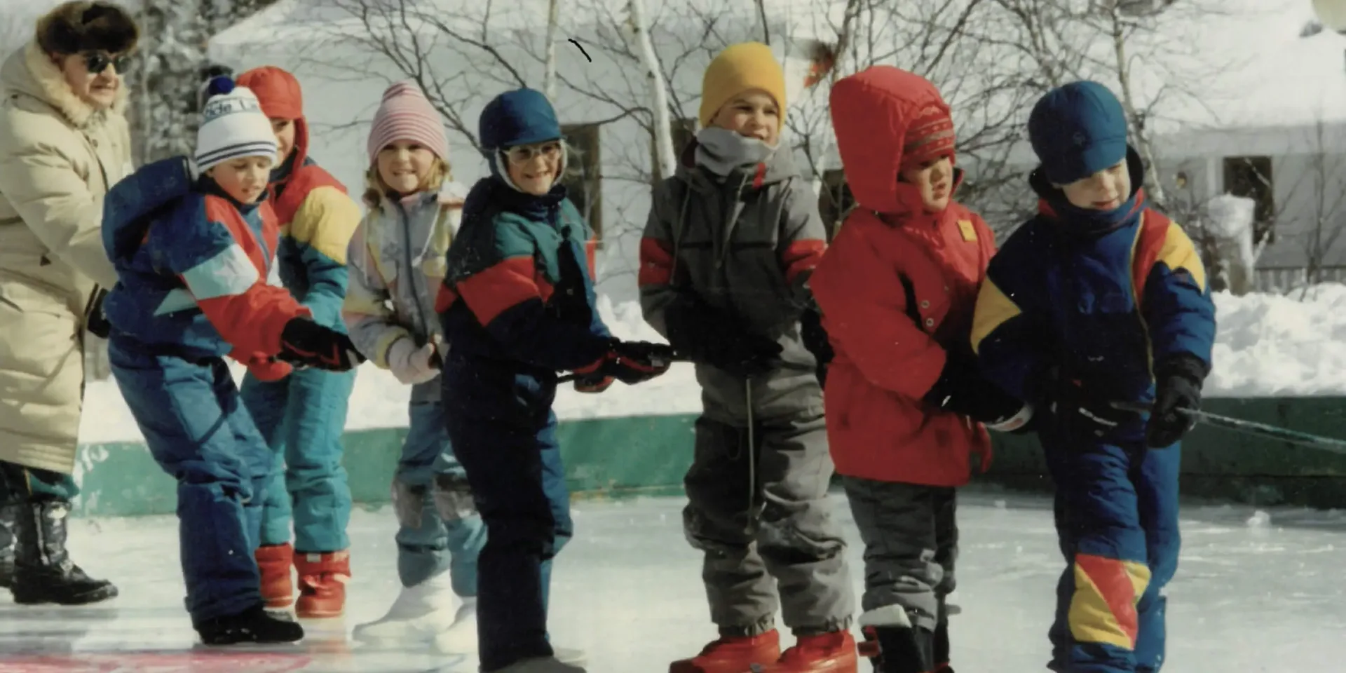 Children playing tug-of-war on outdoor ice rink